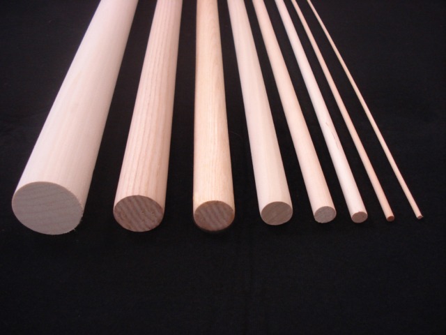 Eight custom wood dowels arranged in descending order of diameter, showcasing a variety of size options for bulk orders.